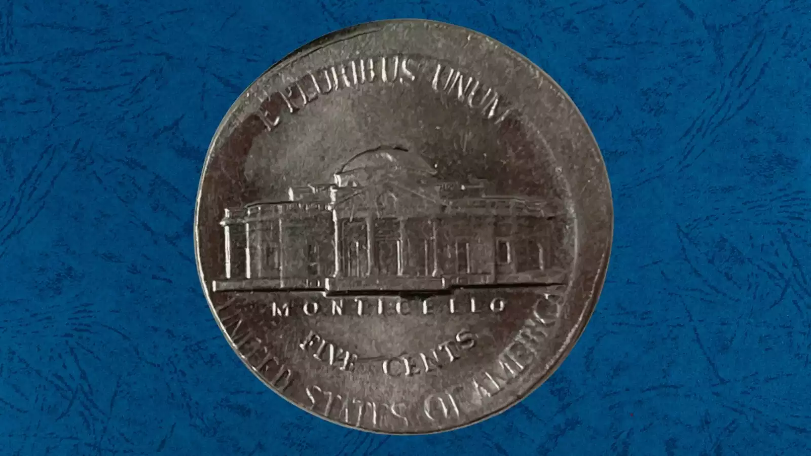 1991 Jefferson nickel off-center strike error showing partial blank rim and shifted design